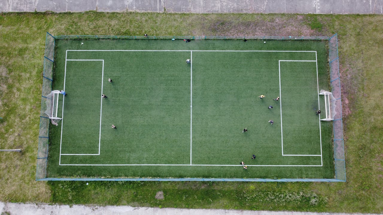Aerial view of a soccer game on a green field in Krasnoyarsk Krai, Russia.