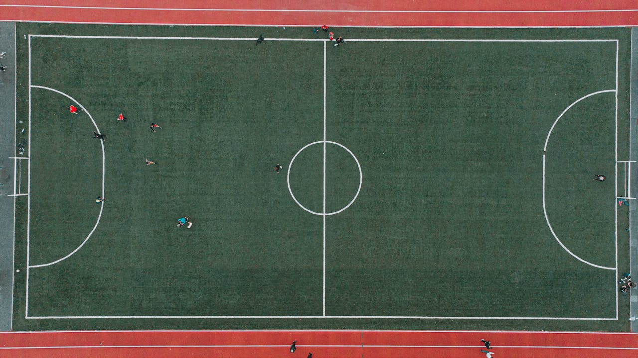 Aerial shot of a soccer match on a green field with players in Lviv, Ukraine.
